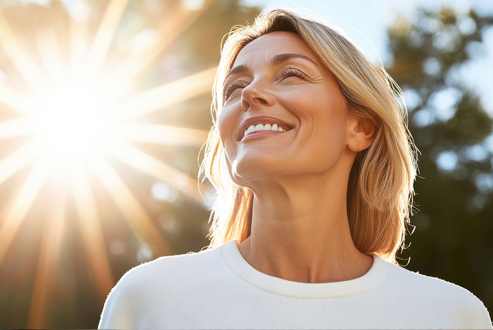 Portrait of happy mature woman enjoying wonderful sunny day in nature