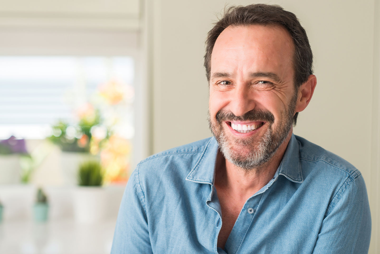 older person smiling brightly within the comfort of their own home