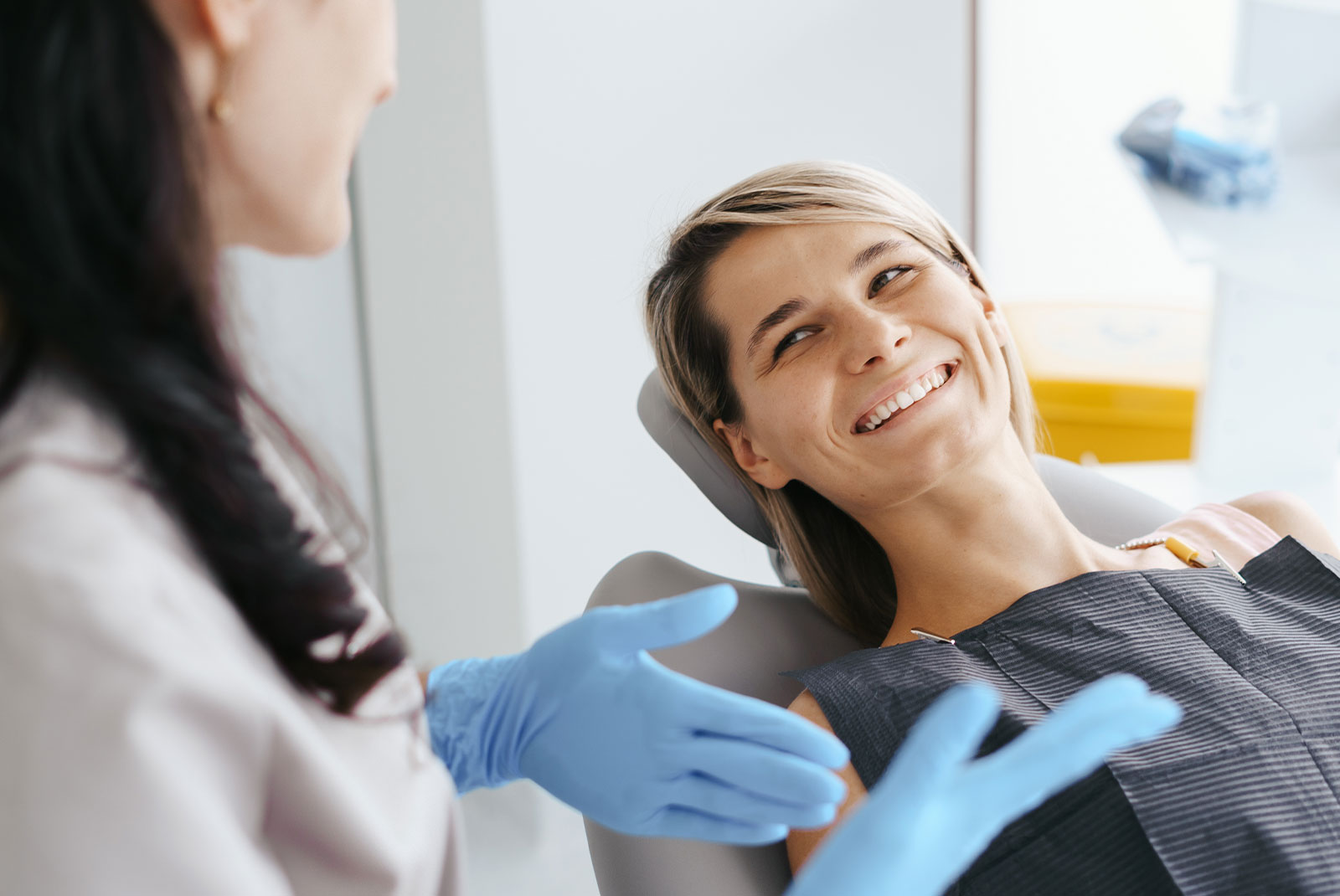 patient smiling and going over dental procedure information with staff member