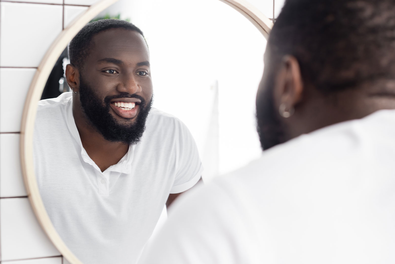 person smiling brightly in the mirror